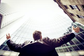 low-angle photography of man in the middle of buidligns by Razvan Chisu courtesy of Unsplash.